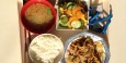 klassische Mahlzeit mit Reis, Misosuppe, Grüntee, Salat und gekochtem Schweinefleisch mit Gemüse